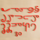 Child engaging with the wooden Telugu alphabet, arranging letters on a table for language practice.